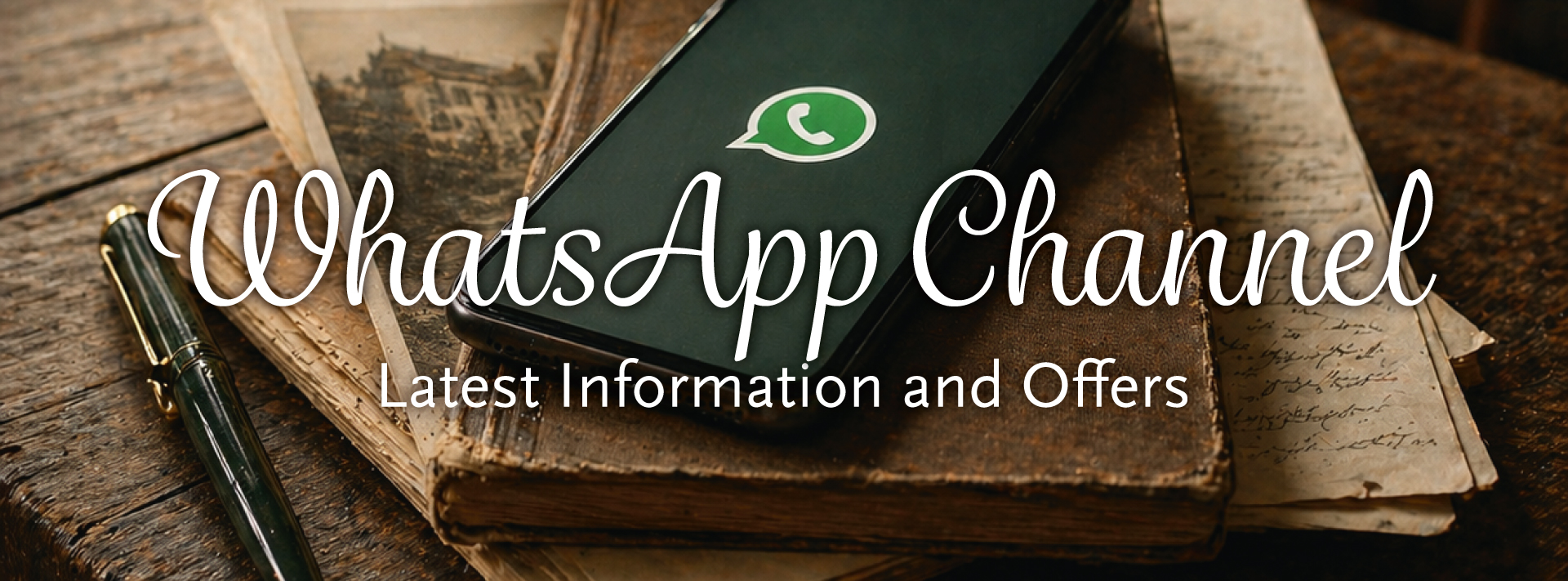 Smartphone with WhatsApp logo on vintage books; promoting our WhatsApp channel for the latest info and offers